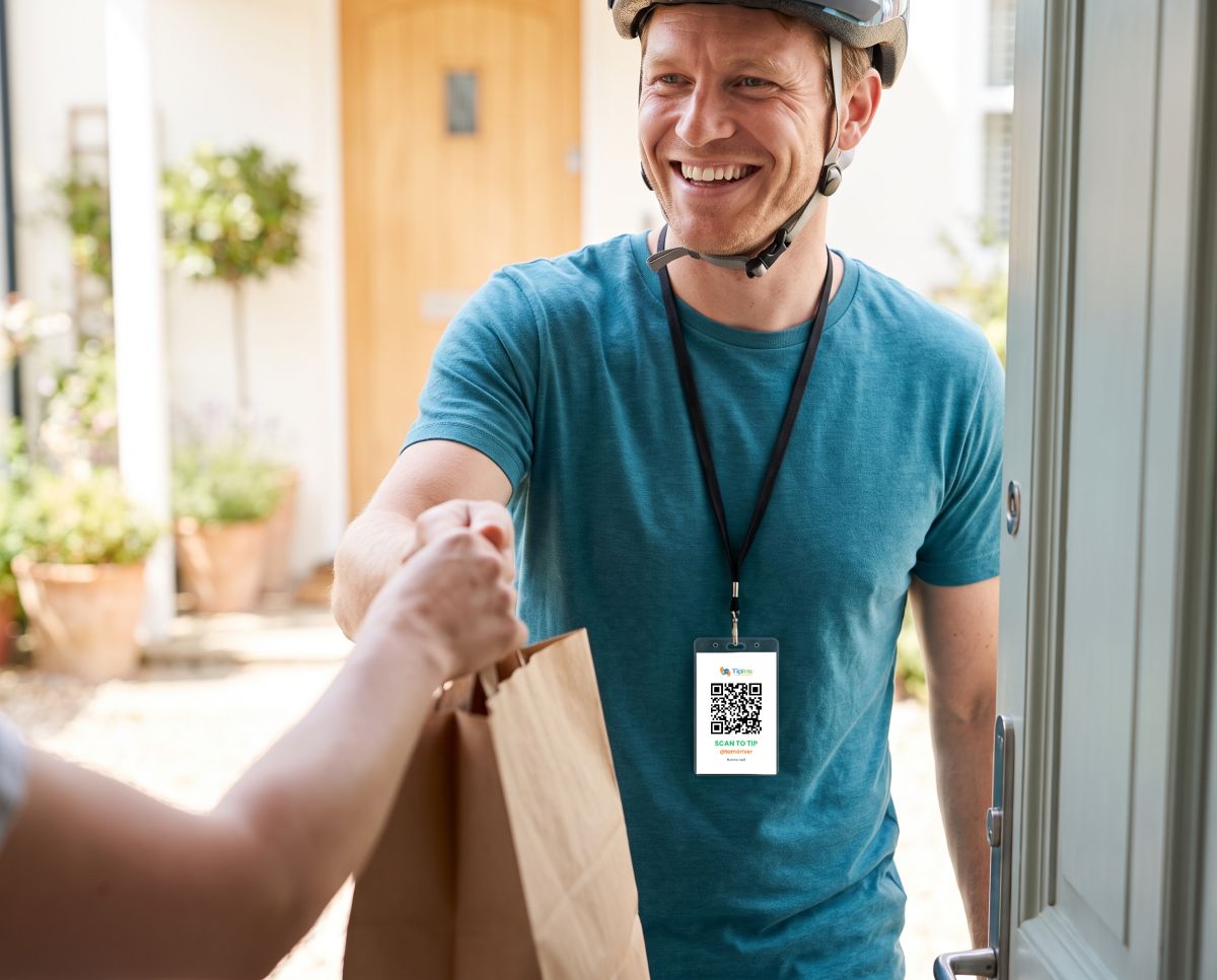 A delivery rider handing over an order