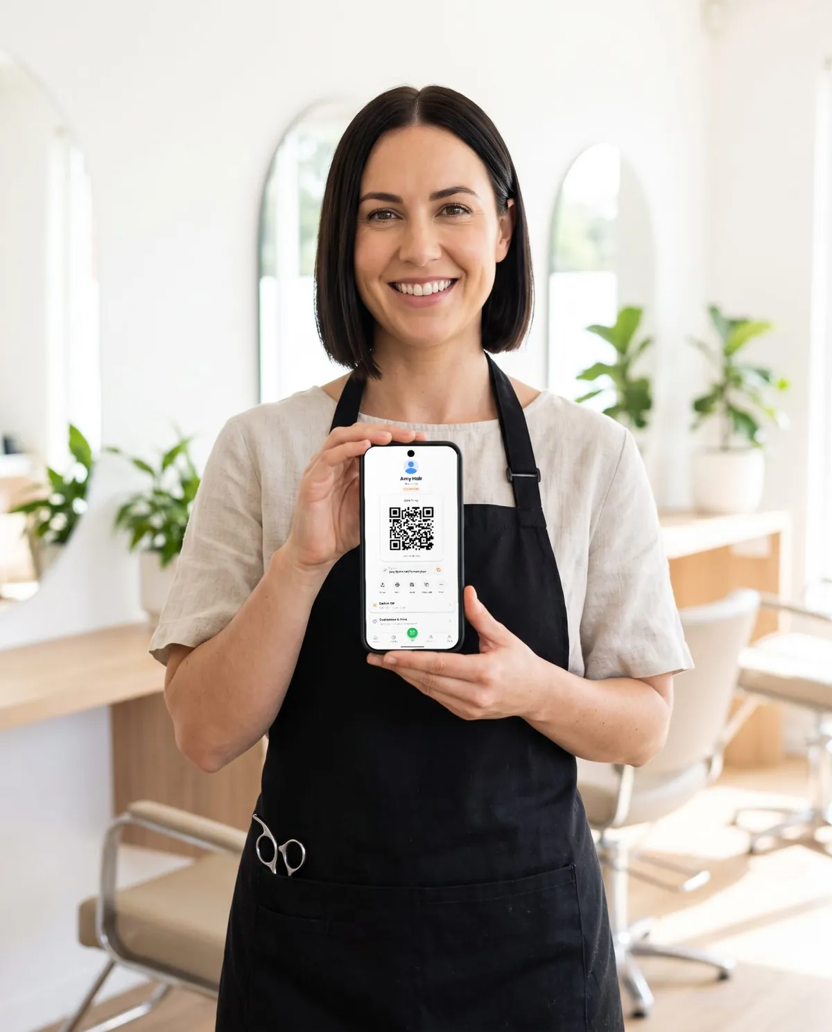 A salon professional holding a phone that shows her QR code for tips